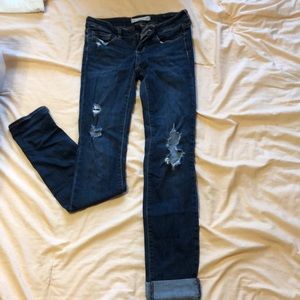 dark blue jeans with rips